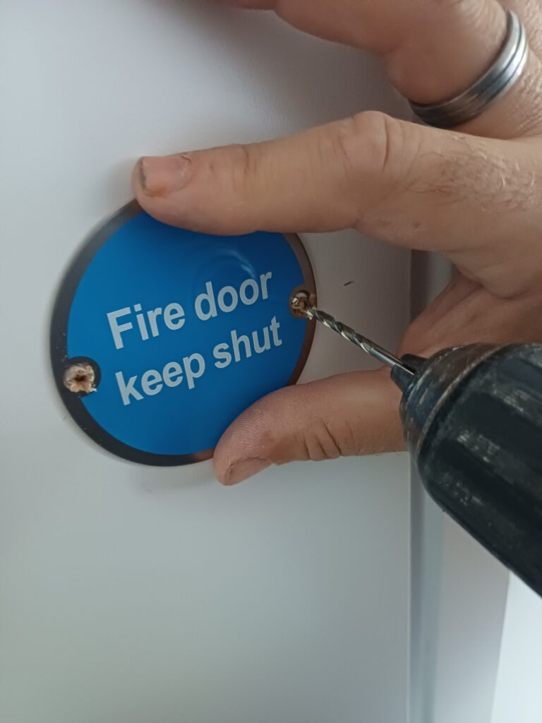 fixing signage on a fire door