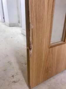 Damaged lipping and door leaf requiring inspection