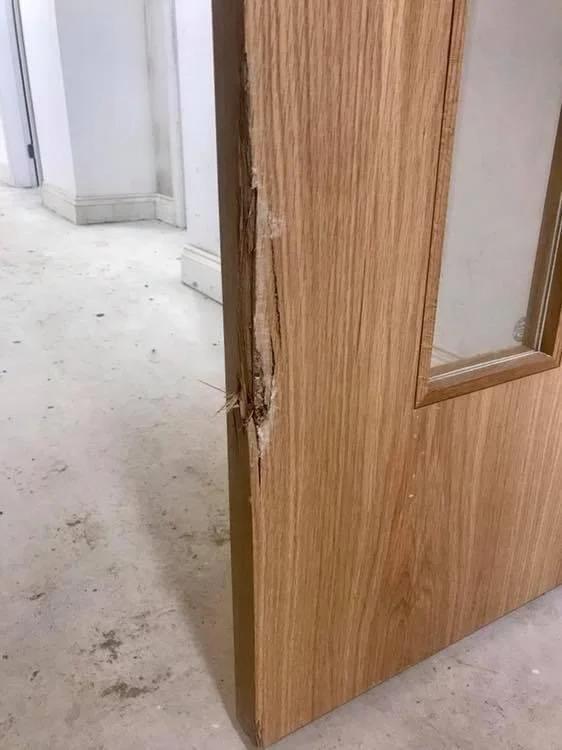 Split and damaged lipping extending into the fire door leaf